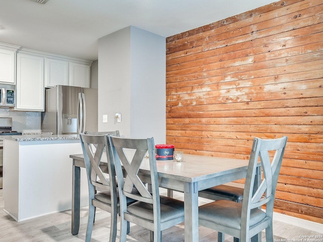 dining room with light hardwood / wood-style floors