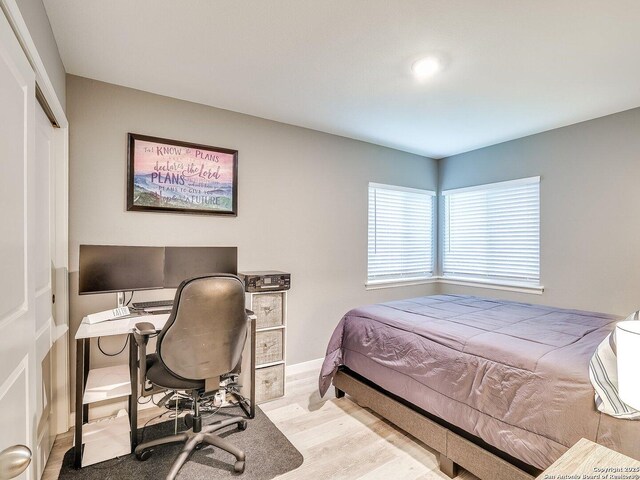 bedroom with a closet and light wood-type flooring