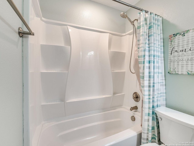 bathroom featuring shower / bath combo and toilet