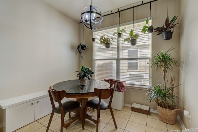 tiled dining area with an inviting chandelier