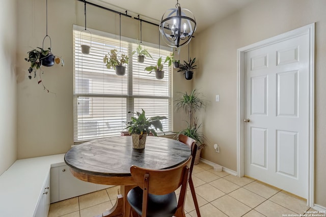 tiled dining space with a notable chandelier