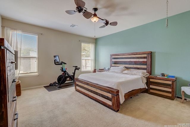 bedroom with ceiling fan and light colored carpet