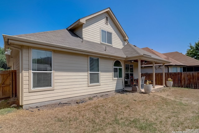 back of house featuring a yard, ceiling fan, and a patio area