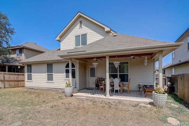 rear view of property with a yard, a patio, and ceiling fan