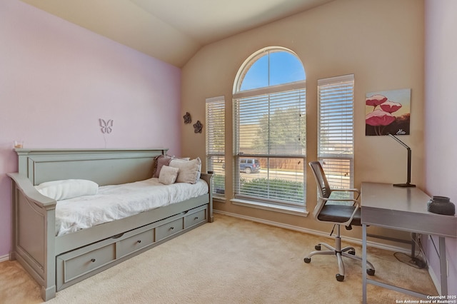 carpeted bedroom with vaulted ceiling