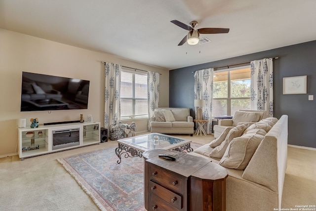 living room featuring light carpet and ceiling fan