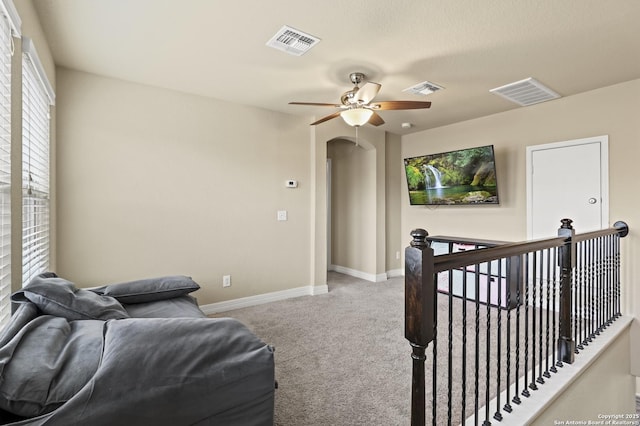 carpeted living room with ceiling fan