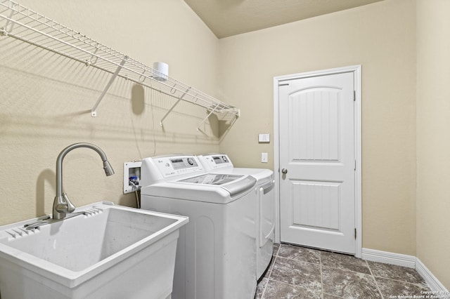 clothes washing area featuring independent washer and dryer and sink