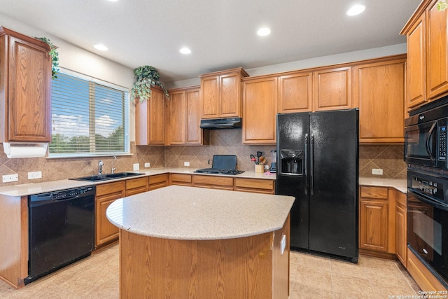 kitchen with backsplash, sink, a center island, and black appliances