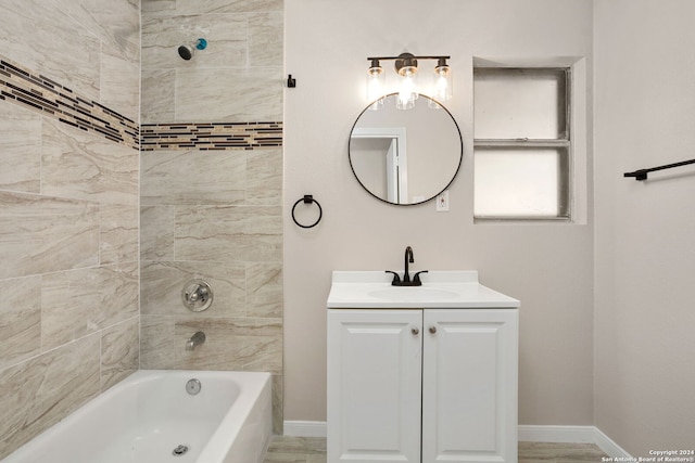 bathroom with vanity and tiled shower / bath