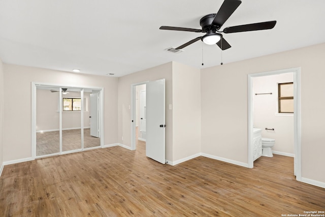 unfurnished bedroom featuring connected bathroom, a closet, ceiling fan, and light hardwood / wood-style floors