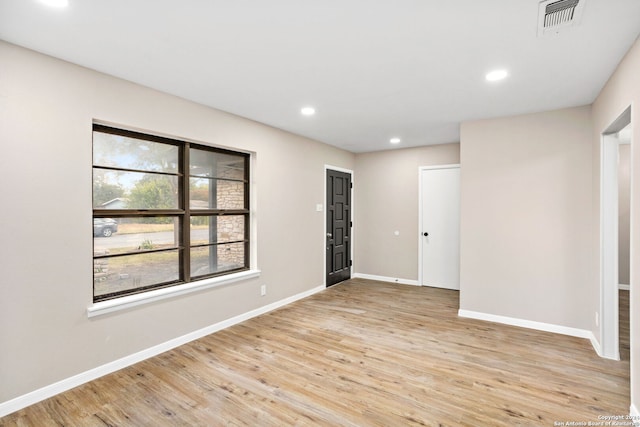 spare room with light wood-type flooring