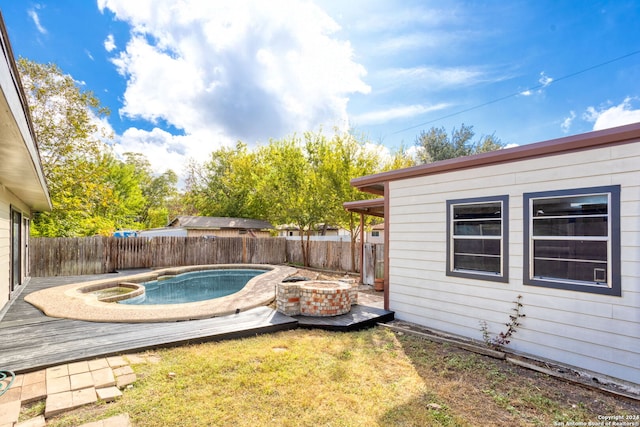 view of yard featuring a swimming pool side deck and an outdoor fire pit