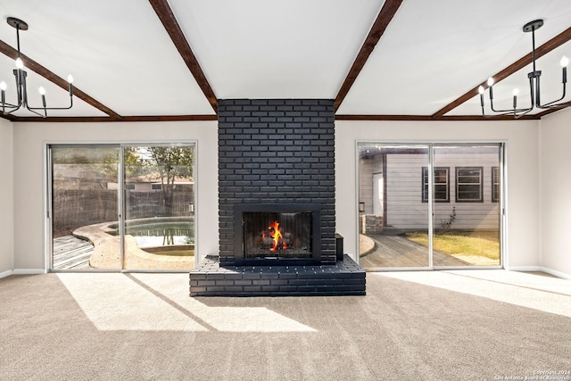 unfurnished living room featuring carpet flooring, an inviting chandelier, and a brick fireplace