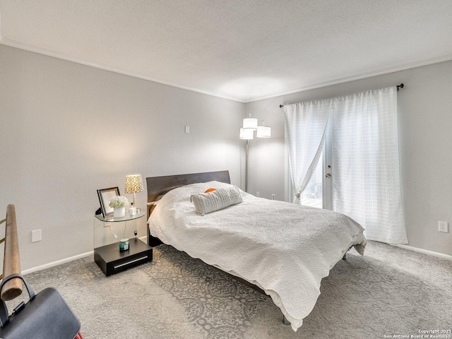 carpeted bedroom with a textured ceiling and ornamental molding