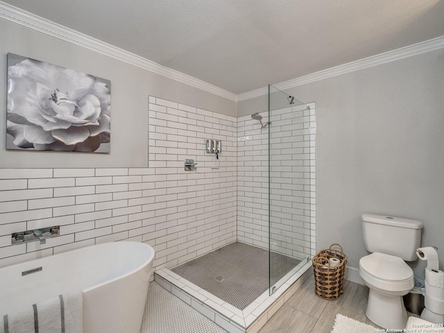 bathroom featuring toilet, a textured ceiling, separate shower and tub, and crown molding