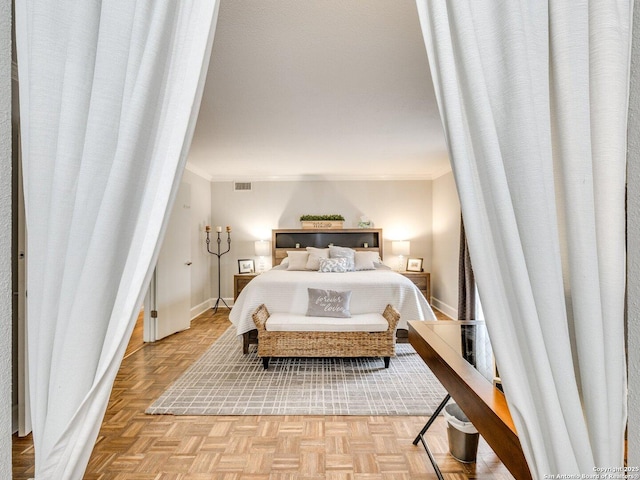 bedroom featuring crown molding and light parquet floors