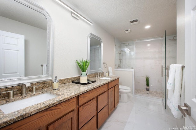 bathroom featuring toilet, vanity, a textured ceiling, and walk in shower