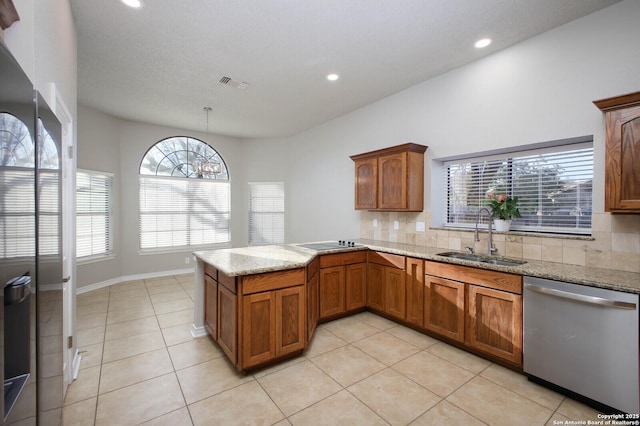 kitchen featuring pendant lighting, dishwasher, sink, light stone countertops, and light tile patterned floors