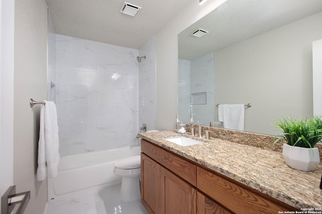 full bathroom featuring vanity, toilet, a textured ceiling, and tiled shower / bath combo