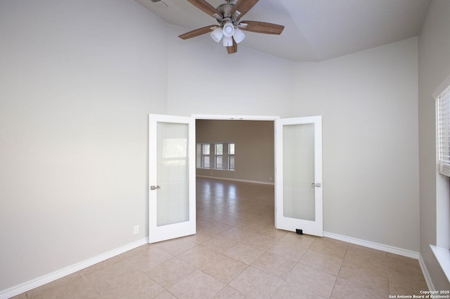 unfurnished room featuring ceiling fan, french doors, high vaulted ceiling, and light tile patterned flooring