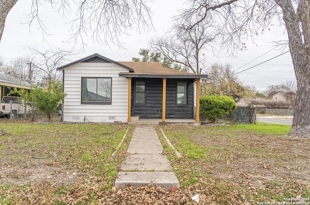 bungalow-style home with a front yard