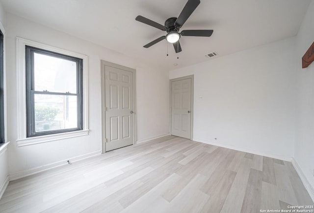 unfurnished room with ceiling fan and light wood-type flooring