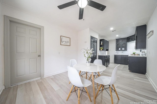 dining space with ceiling fan and light hardwood / wood-style floors