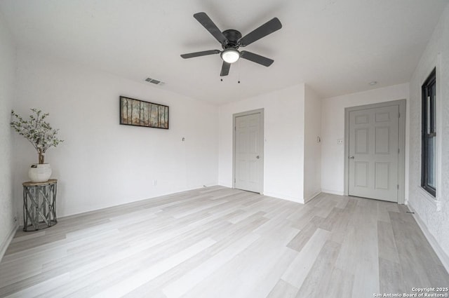 unfurnished room with ceiling fan and light hardwood / wood-style flooring