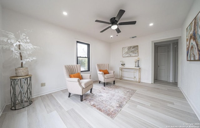 sitting room featuring ceiling fan and light wood-type flooring