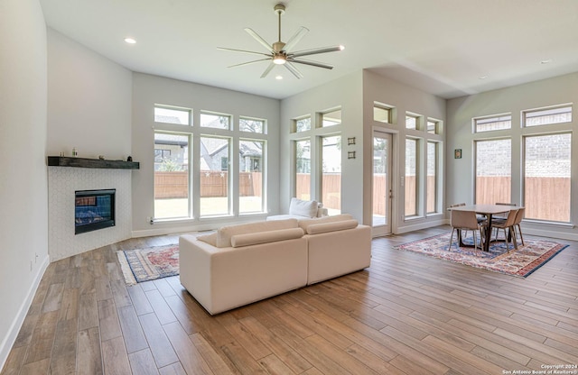 living room with a healthy amount of sunlight, ceiling fan, and light hardwood / wood-style floors