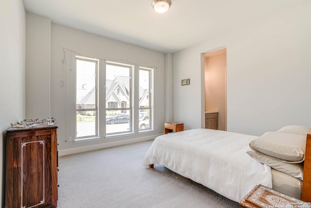 carpeted bedroom with connected bathroom