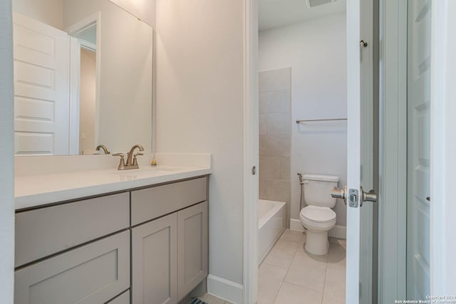 bathroom featuring toilet, vanity, and tile patterned floors