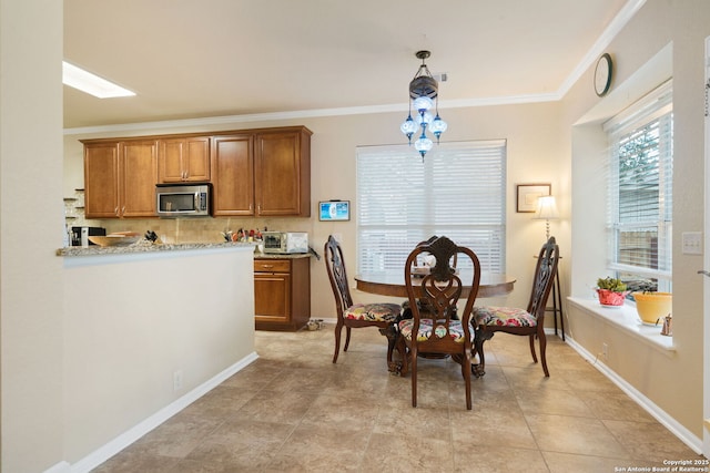 dining area with a chandelier and ornamental molding