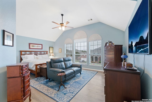 bedroom featuring light wood-type flooring, vaulted ceiling, and ceiling fan