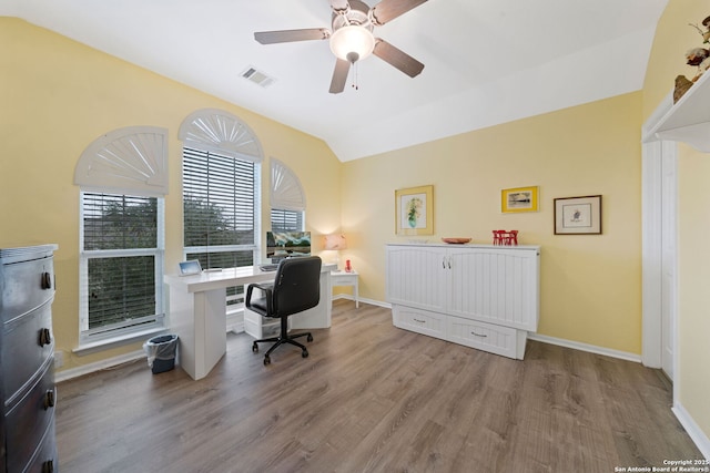 office area featuring ceiling fan, light wood-type flooring, and vaulted ceiling