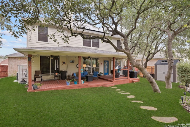 back of house with a yard, a wooden deck, outdoor lounge area, and a storage shed