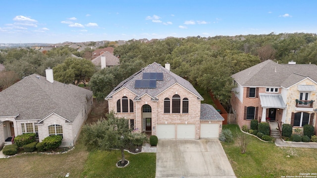 view of front of home featuring a garage and solar panels