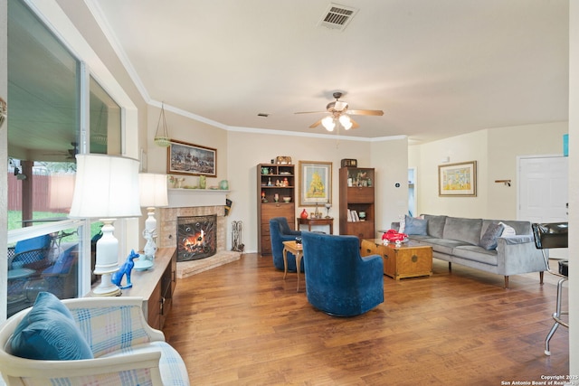 living room with ceiling fan, crown molding, and hardwood / wood-style flooring