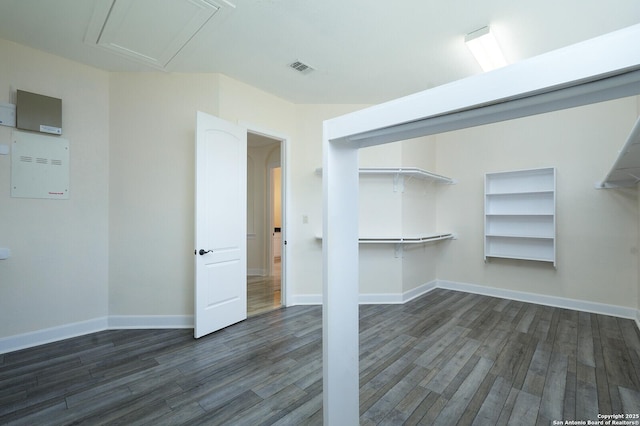 walk in closet with dark wood-type flooring