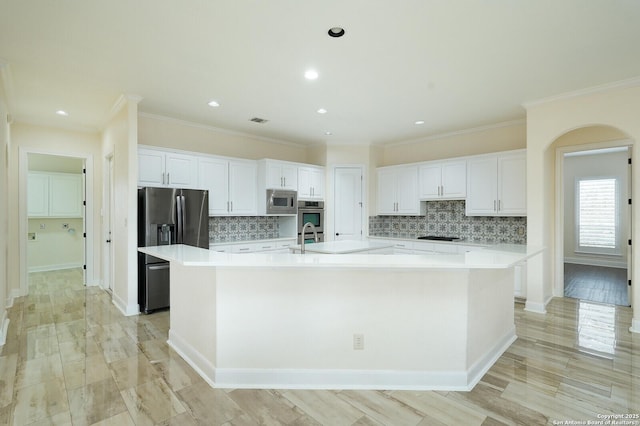 kitchen with a large island, sink, white cabinets, and stainless steel appliances