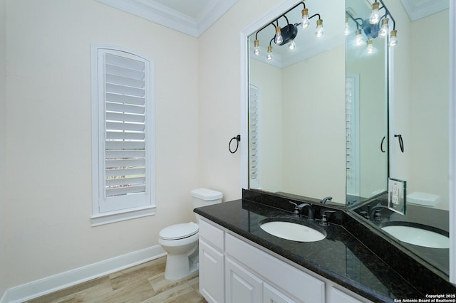 bathroom featuring hardwood / wood-style flooring, vanity, toilet, and crown molding