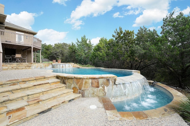 view of swimming pool with pool water feature