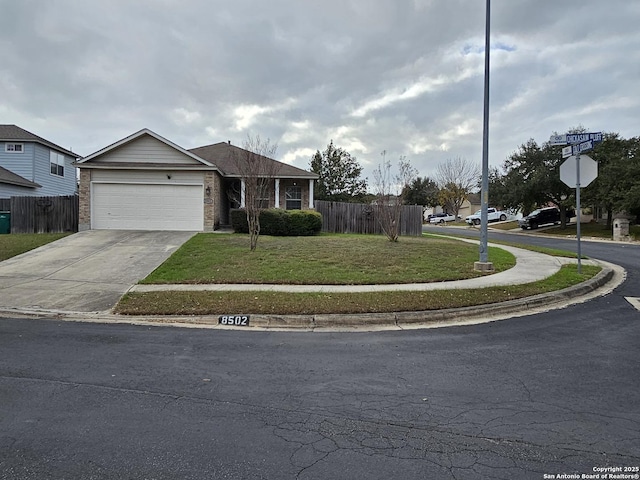 view of front of property with a garage and a front lawn