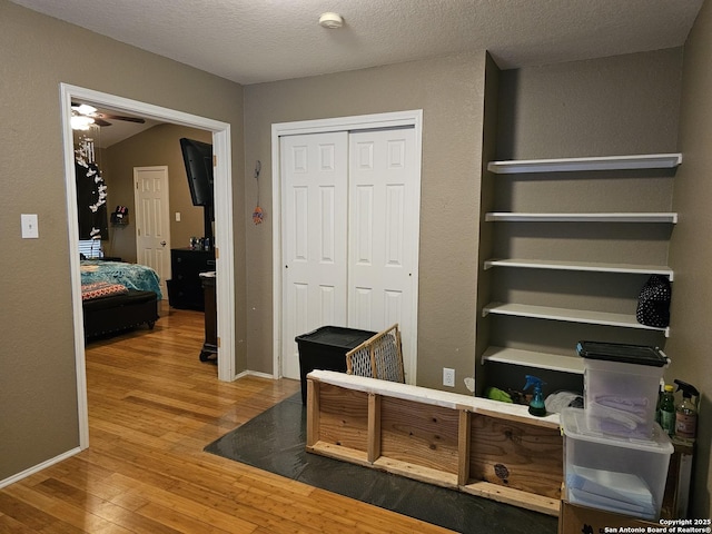 interior space featuring hardwood / wood-style flooring and a textured ceiling