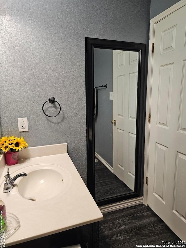 bathroom featuring wood-type flooring and vanity