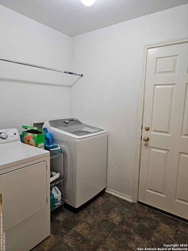 clothes washing area featuring washing machine and clothes dryer