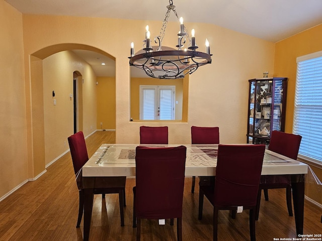 dining area with a notable chandelier and hardwood / wood-style flooring