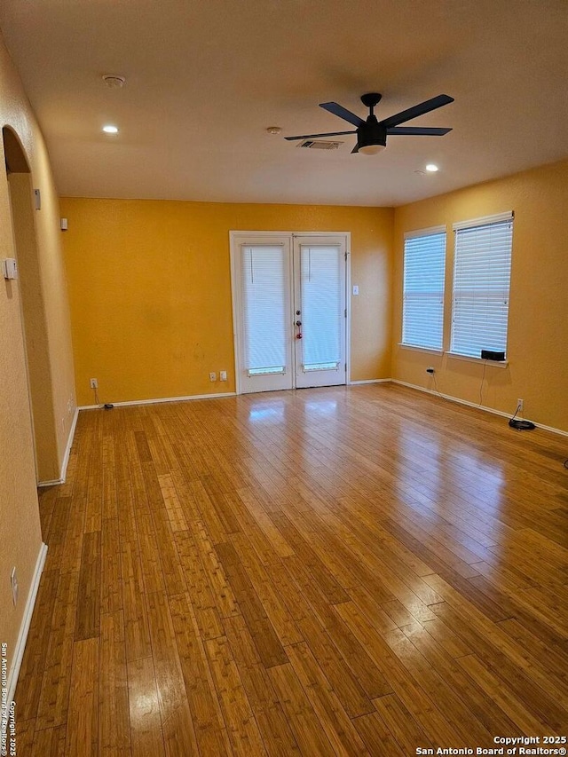 unfurnished room featuring french doors, light hardwood / wood-style floors, and ceiling fan