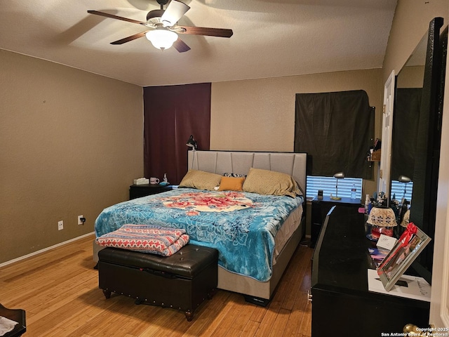 bedroom featuring ceiling fan and light hardwood / wood-style floors